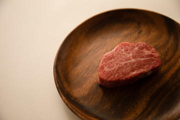 Raw meat on the wooden plate