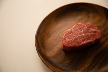 Raw meat on the wooden plate