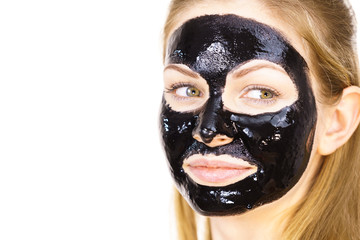 Woman with black peel off mask on face