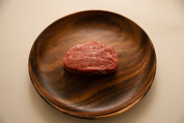 Raw meat on the wooden plate