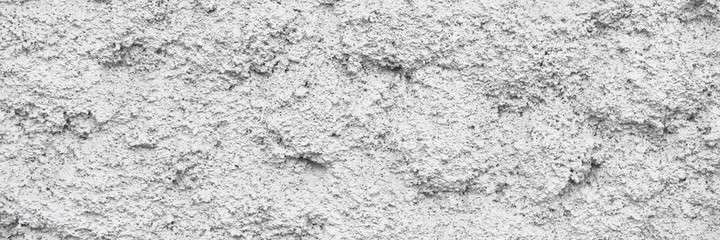 The texture of the gray wall. Decorative plaster.  Rough grainy bumpy surface. Wide panoramic texture for background and design.