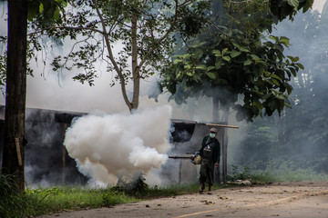 Officers enter the area to spray fog to prevent dengue fever.