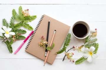 notebook planner for business work with hot coffee espresso ,flower arrangement flat lay style on background white 