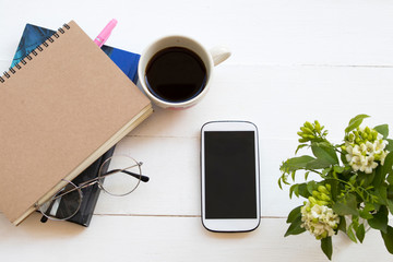 notebook planner ,mobile phone for business work with hot coffee espresso ,flower arrangement flat lay style on background white 