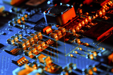 Electronic circuit board with electronic components such as chips close up. Blurry background.	