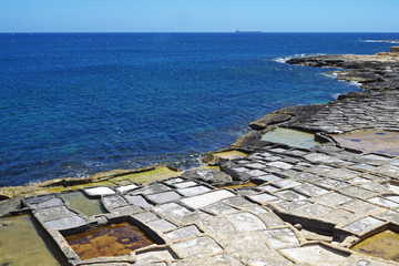 view of the coast with salt pans in the mediterranean sea, Malta