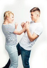 young pretty teenage couple, hipster guy with his girlfriend happy smiling and hugging isolated on white background, lifestyle people concept