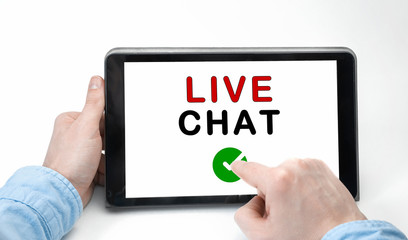 Male hands holding tablet pc with text LIVE CHAT on white background