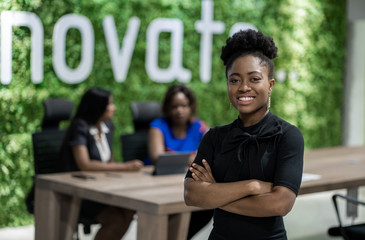 Young North African businesswoman smiling while standing in an office boardroom