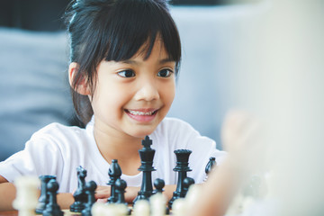 asian girl playing chess boardgames