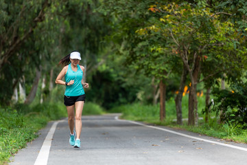 Healthy woman jogging run and workout on road outdoor. Asian runner people exercise gym with fitness session