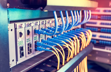 Fiber Optic cables connected to an optic ports and Network cables connected to ethernet ports