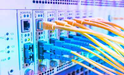 Fiber Optic cables connected to an optic ports and Network cables connected to ethernet ports