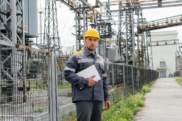 The energy engineer inspects the equipment of the substation. Power engineering. Industry