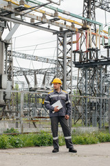 The energy engineer inspects the equipment of the substation. Power engineering. Industry