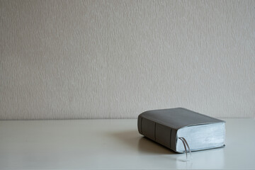 A book on the desk at gray wall background