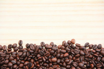 natural black coffee beans on a wooden background