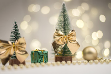 Little Christmas trees decorated and gifts for the new year on the bokeh background, new year mood 2021