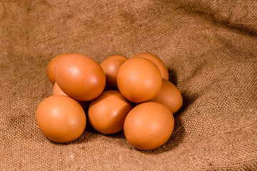 Pile of the hen eggs on sackcloth