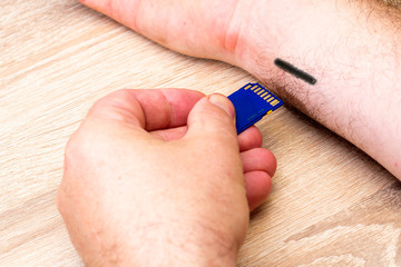 concept of chipization robotization protection of information a person inserts a flash card into...