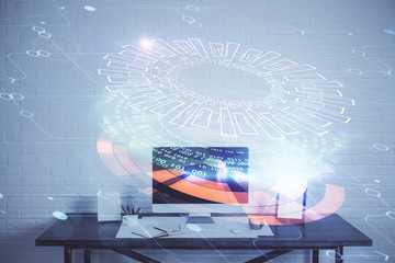 Double exposure of desktop computer and technology theme hologram. Concept of software development.