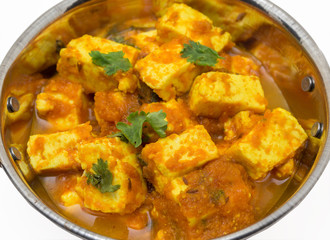 Home made recepie of kadahi paneer or paneer butter masala served in a brass bowl isolated on white available with clipping mask