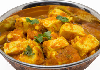 Home made recepie of kadahi paneer or paneer butter masala served in a brass bowl isolated on white available with clipping mask