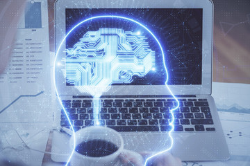 Multi exposure of work space with computer and human brain hologram. Brainstorm concept.