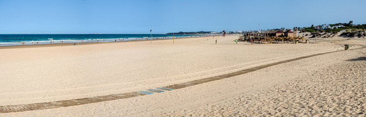 La Barrosa beach in Sancti Petri, Cádiz, with a large amount of sand without water as the tide is low