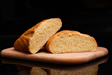 Homemade bread. Baking at home. Round bread on a wooden board.
