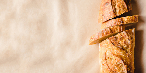 Fresh sliced bread on kraft paper. Close up. Banner with copy space for text.