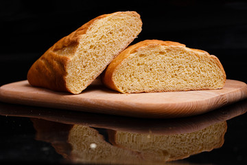 Homemade bread. Baking at home. Round bread on a wooden board.