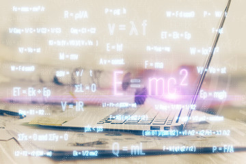 Desktop computer background and formula hologram writing. Double exposure. Education concept.
