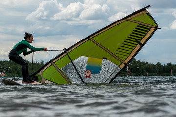 Woman learning winsurfing on the Markkleeberger Lake near Leipzig
