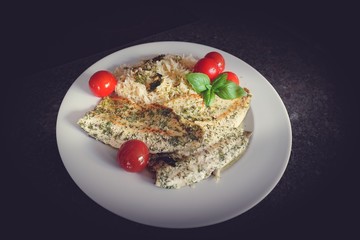 ready to eat -a roasted trout with rice and cherry tomatoes in olive oil