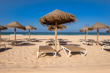Parasols and hammocks on La Barrosa beach in Sancti Petri, Cadiz, Spain