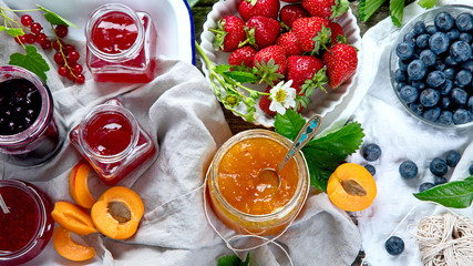 Assortment of jams and seasonal berries, fruits