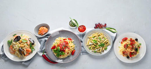 Plates of pastas with different kinds of sauces.