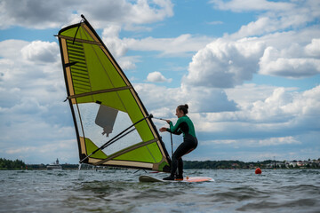 Naklejka premium Woman participating in a windsurfing course