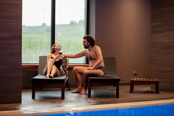 Couple relaxing by the swimming pool