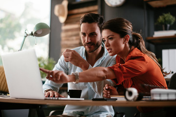 Colleagues in office. Businesswoman and businessman discussing work in office. Two friends in working together.