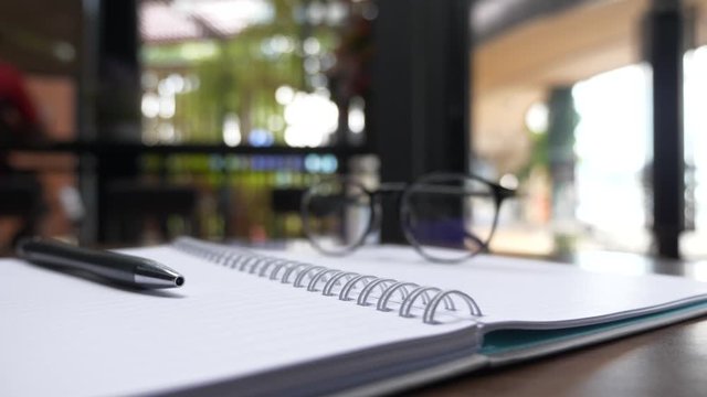 notebook pen and glasses , working concept.