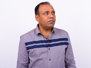 Fototapeta premium Portrait of mature overweight Indian businessman against white background