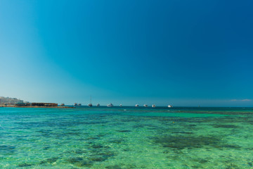 Fototapeta na wymiar transparent wavy red sea water surface with horizon on background
