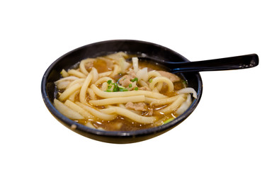 Udon Noodle Soup and Pork with spoon on white background