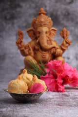 Ganesh Puja - Sweet Modak food offered on Ganpati festival or Chaturthi in India. served in silver bowl on white background.