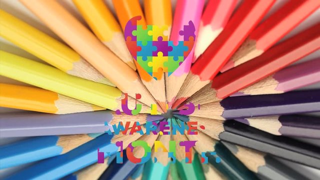 Jigsaw forming a heart and autism awareness month text against colorful pencils spinning