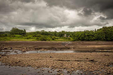 The original Water of Ken river bed exposed and the Earlstoun Castle ruin