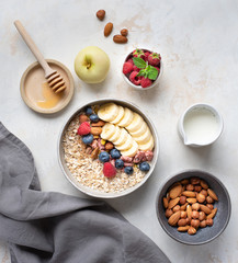Healthy diet. Oatmeal. Ingredients for porridge. Wholesome breakfast. Delicious summer berries. Useful nuts.