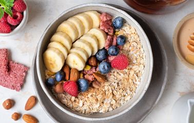 Healthy diet. Oatmeal. Ingredients for porridge. Wholesome breakfast. Delicious summer berries. Useful nuts.